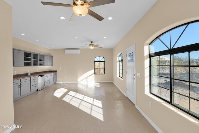 living room featuring ceiling fan and a wall mounted air conditioner