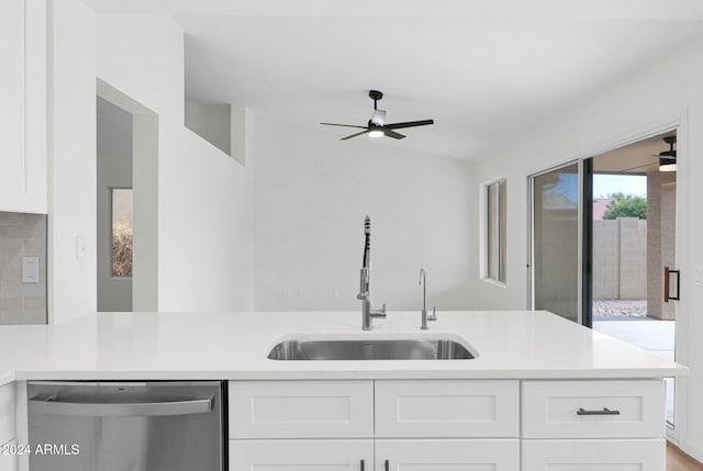 kitchen featuring lofted ceiling, sink, stainless steel dishwasher, light hardwood / wood-style floors, and white cabinetry