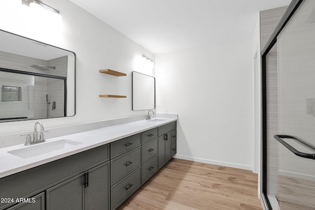 bathroom featuring vanity, an enclosed shower, and wood-type flooring