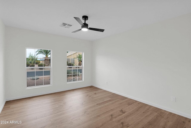 spare room with light hardwood / wood-style floors and ceiling fan