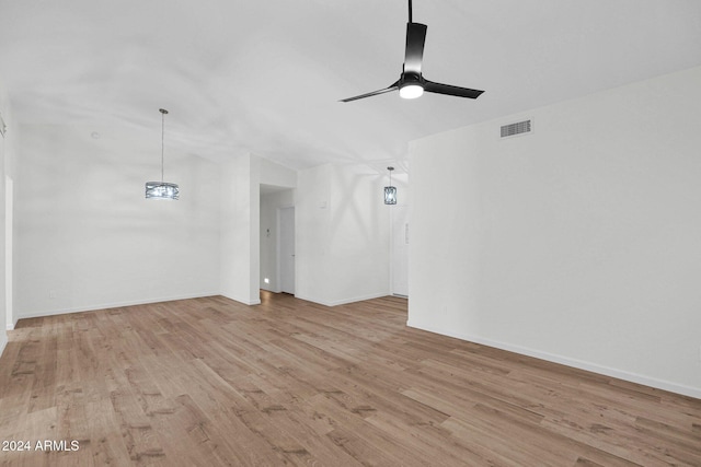 unfurnished living room featuring ceiling fan and light hardwood / wood-style flooring