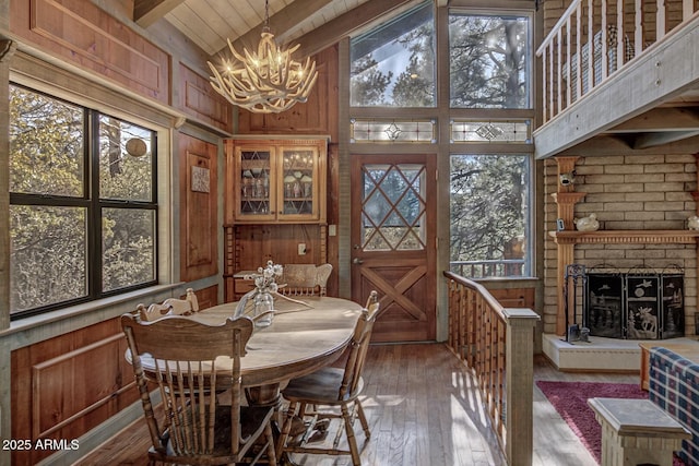 dining space with a wealth of natural light and wooden walls