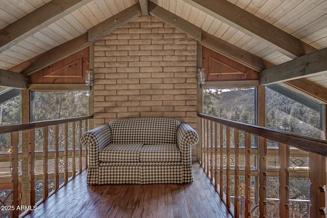 unfurnished room featuring wood ceiling, wood-type flooring, lofted ceiling with beams, and brick wall