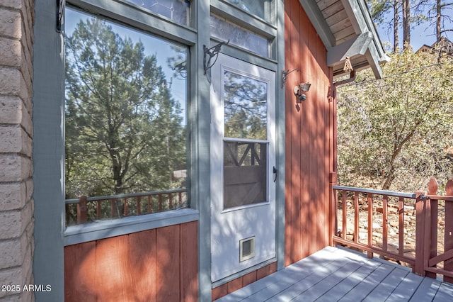 entrance to property with visible vents and a wooden deck