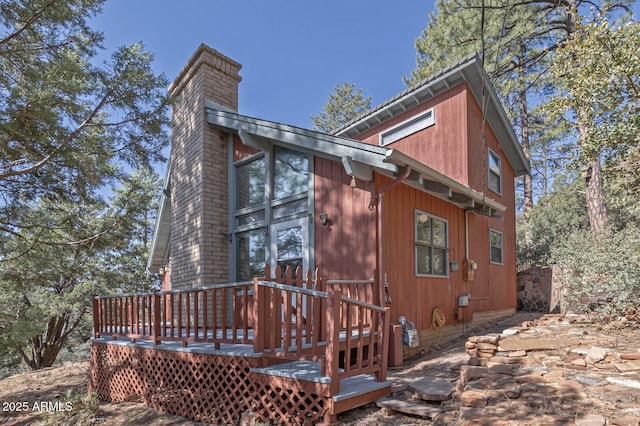 exterior space featuring a chimney and a wooden deck