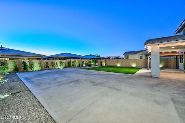 exterior space featuring a patio area, a fenced backyard, and a gazebo