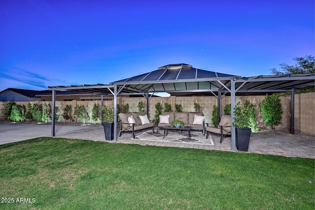 view of patio with a fenced backyard, an outdoor hangout area, and a gazebo