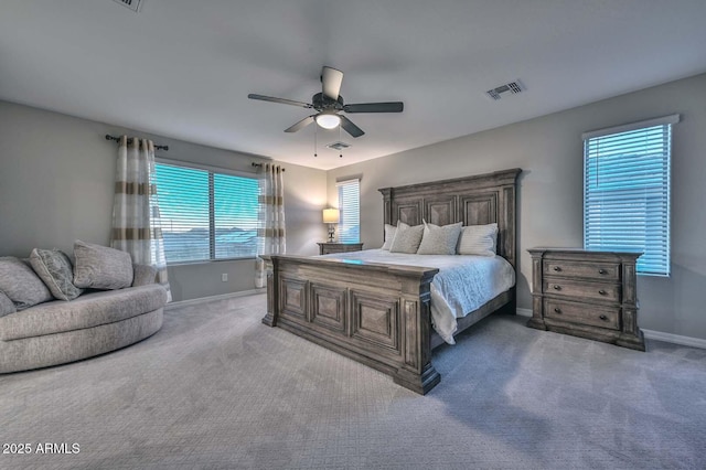 bedroom with carpet floors, baseboards, visible vents, and ceiling fan