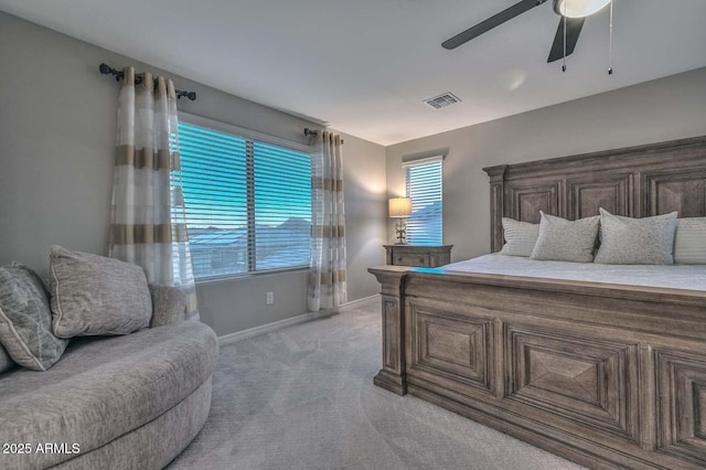 bedroom with light carpet, a ceiling fan, visible vents, and baseboards