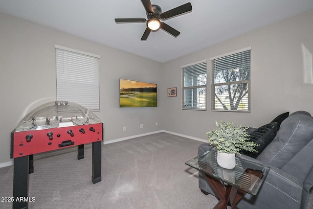 playroom with a ceiling fan, baseboards, and carpet flooring