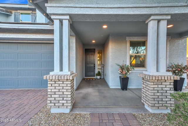 property entrance with a porch and stucco siding