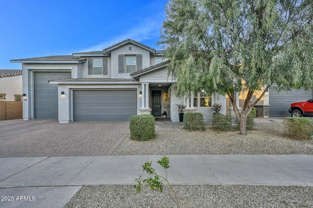 view of front of property with decorative driveway and stucco siding