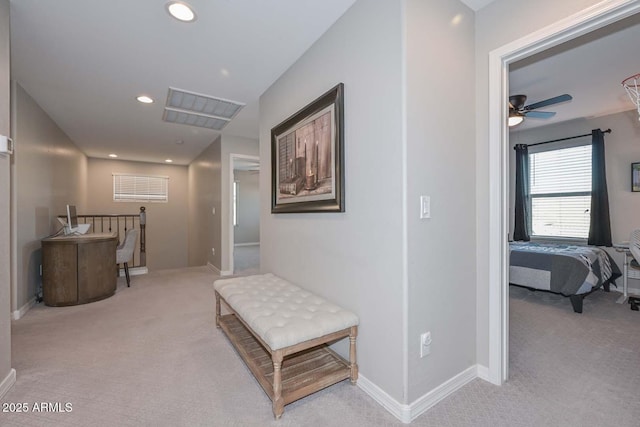 hall featuring recessed lighting, baseboards, and light colored carpet