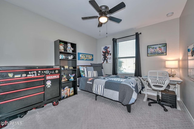 carpeted bedroom with ceiling fan and baseboards