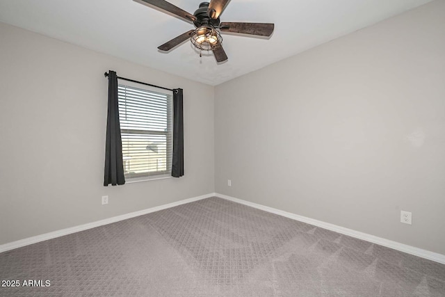 spare room with carpet floors, ceiling fan, and baseboards