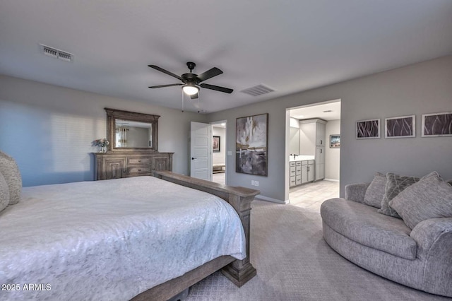 carpeted bedroom featuring baseboards, visible vents, a ceiling fan, and ensuite bathroom