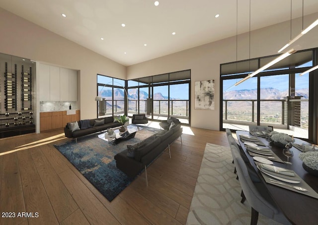 living room with hardwood / wood-style flooring, a mountain view, and high vaulted ceiling