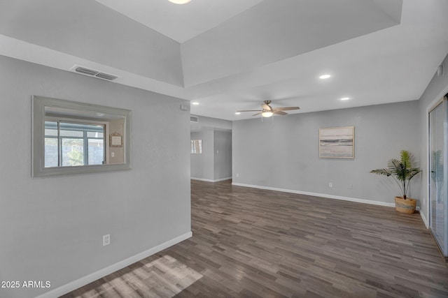 empty room with ceiling fan, recessed lighting, baseboards, wood finished floors, and visible vents
