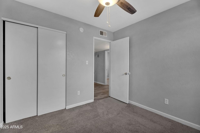 unfurnished bedroom with visible vents, baseboards, carpet floors, and a closet