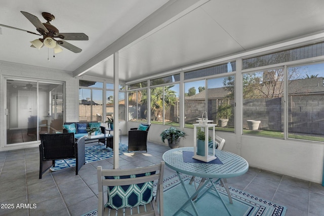 sunroom featuring an outdoor living space, ceiling fan, and a healthy amount of sunlight