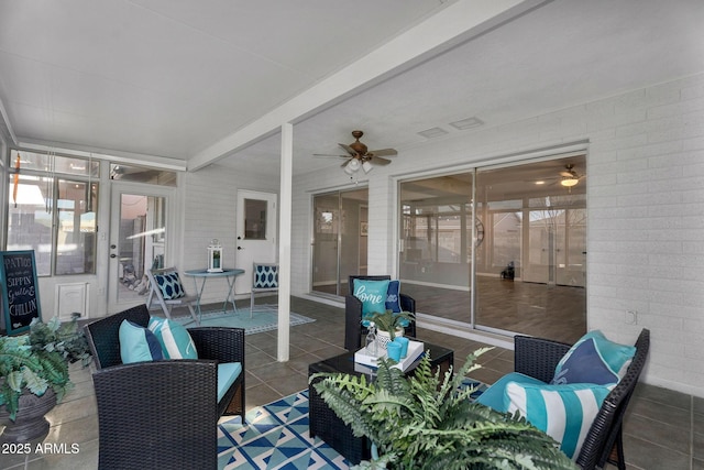 sunroom / solarium featuring a ceiling fan, beamed ceiling, and outdoor lounge area