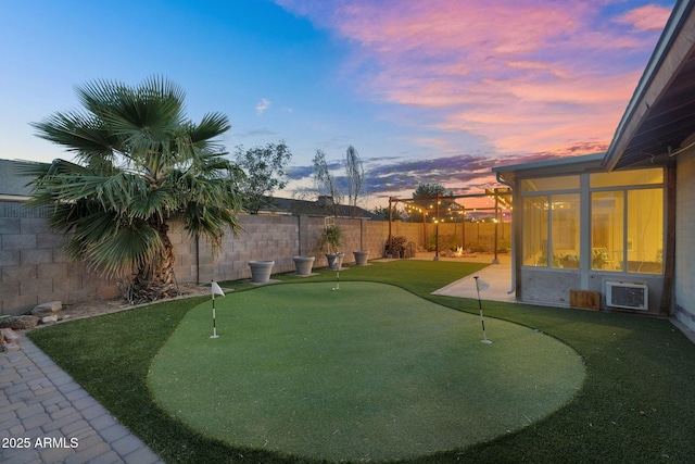 view of yard with a fenced backyard and a sunroom