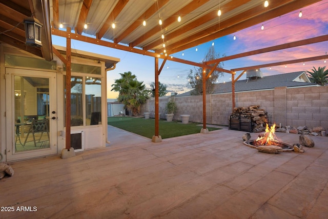 view of patio / terrace with a fire pit and a fenced backyard