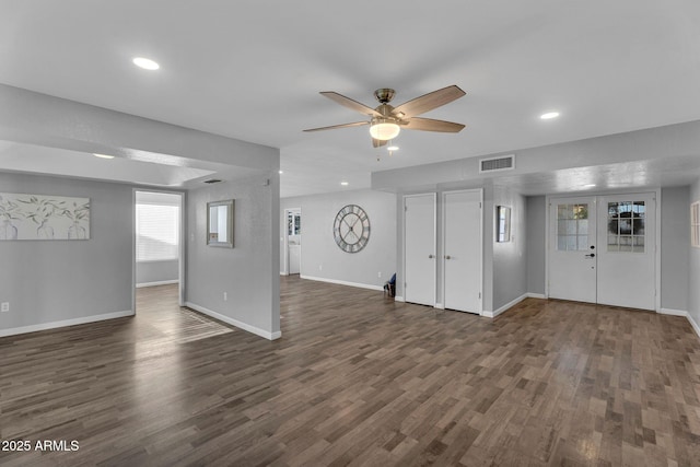 unfurnished living room featuring a ceiling fan, visible vents, baseboards, dark wood-style floors, and recessed lighting