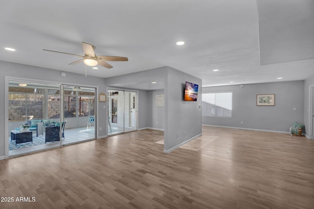 unfurnished living room featuring baseboards, recessed lighting, ceiling fan, and wood finished floors