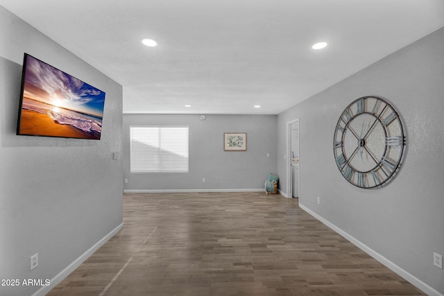 below grade area featuring baseboards, recessed lighting, and wood finished floors