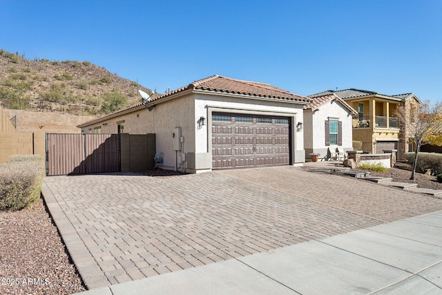 view of front of home with a balcony and a garage