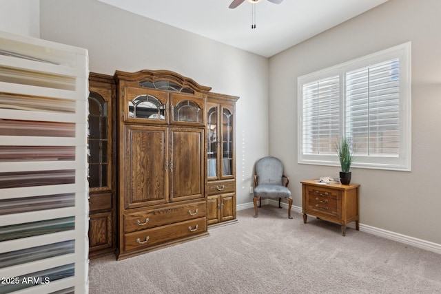 sitting room featuring light carpet and ceiling fan