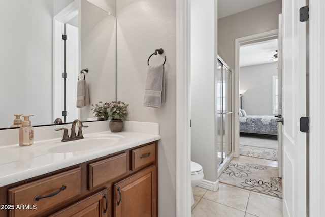 bathroom with toilet, walk in shower, tile patterned flooring, ceiling fan, and vanity