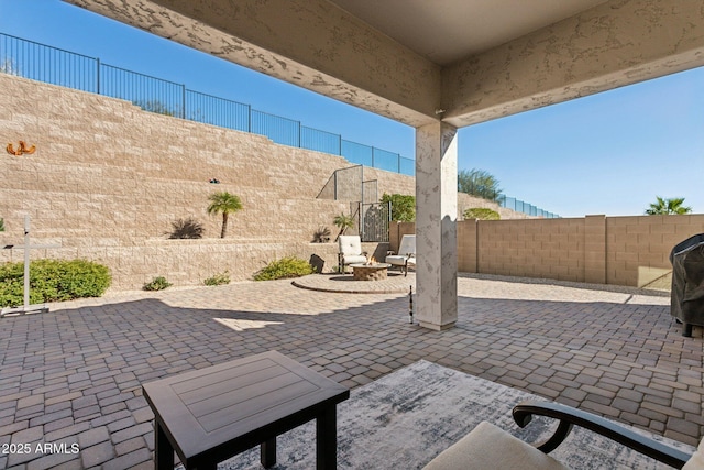 view of patio with grilling area and a fire pit