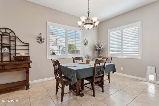 dining space featuring an inviting chandelier and light tile patterned floors