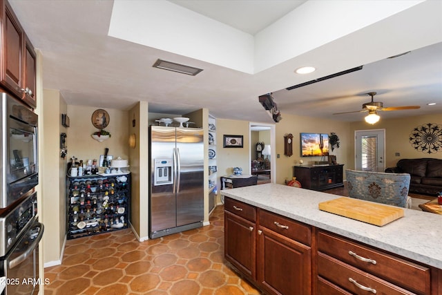 23265 S Via Del Arroyo, Queen Creek, AZ 85142 - kitchen featuring stainless steel appliances, ceiling fan, open floor plan, light stone countertops, and recessed lighting