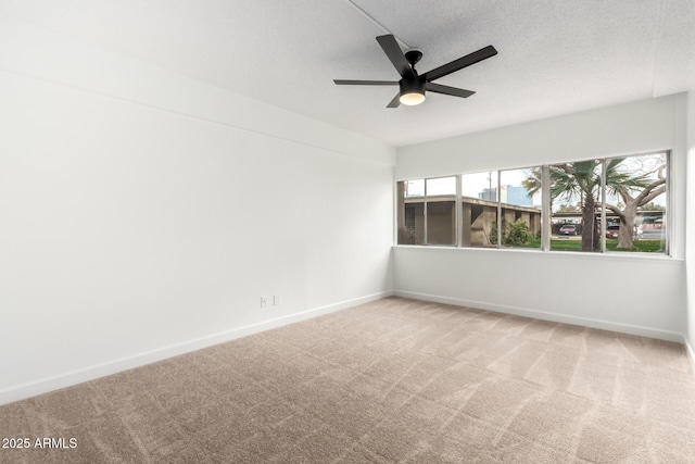 unfurnished room with ceiling fan, a textured ceiling, and carpet flooring