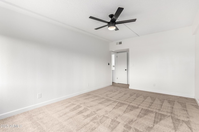 spare room featuring ceiling fan and carpet floors