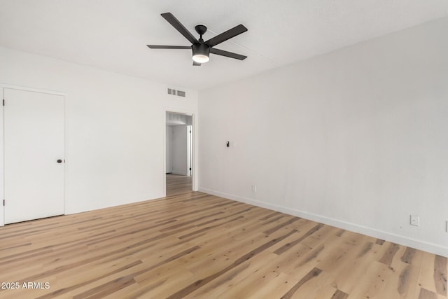 empty room with light hardwood / wood-style flooring and ceiling fan