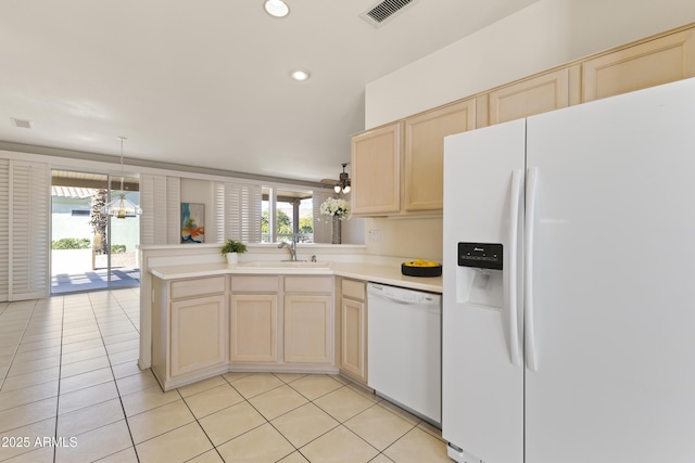 kitchen featuring a peninsula, white appliances, a sink, visible vents, and light countertops