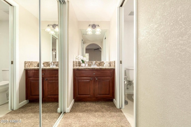 full bathroom with toilet and vanity