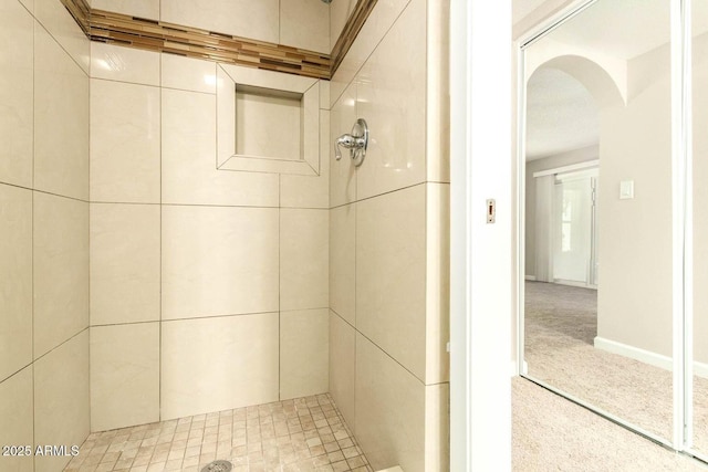 full bath with a tile shower
