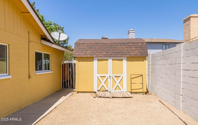view of shed with fence