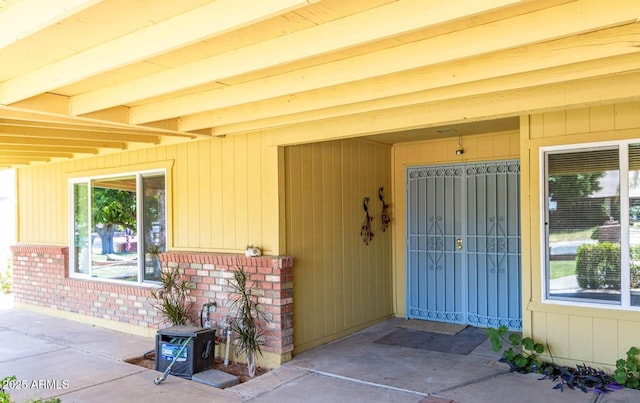 property entrance featuring brick siding