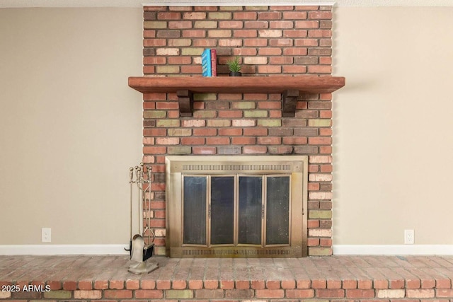 details with a brick fireplace and baseboards