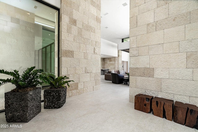 hallway featuring a towering ceiling