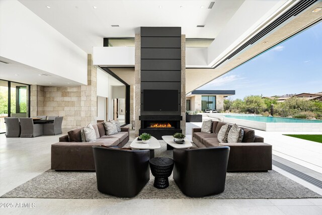 view of patio with an outdoor living space with a fireplace