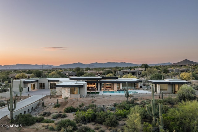 back house at dusk with a mountain view