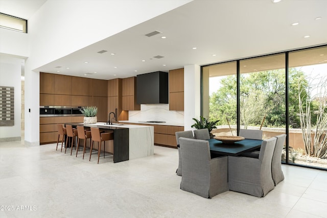 dining room with a wall of windows and sink