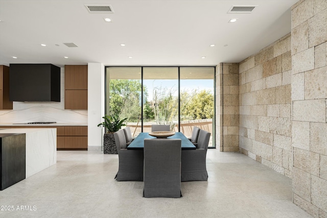 dining space with a wall of windows